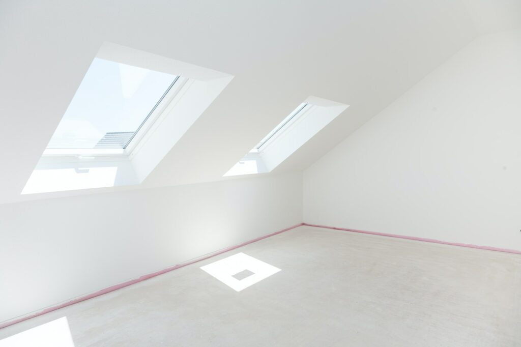 Loft refurbishment - empty room with skylight ready for renovation and new floor