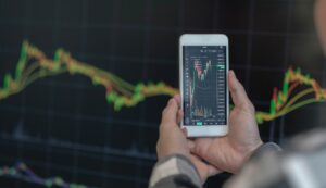 Business man trader investor analyst using mobile phone app analytics for cryptocurrency financial