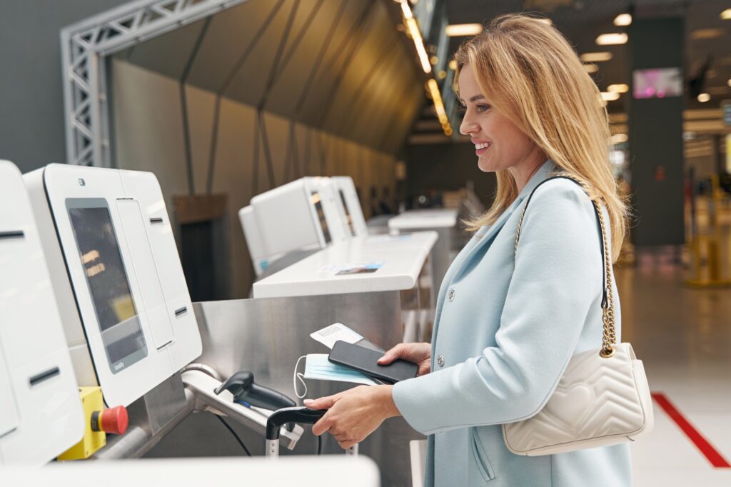 Smiling tourist checking in her baggage before flight